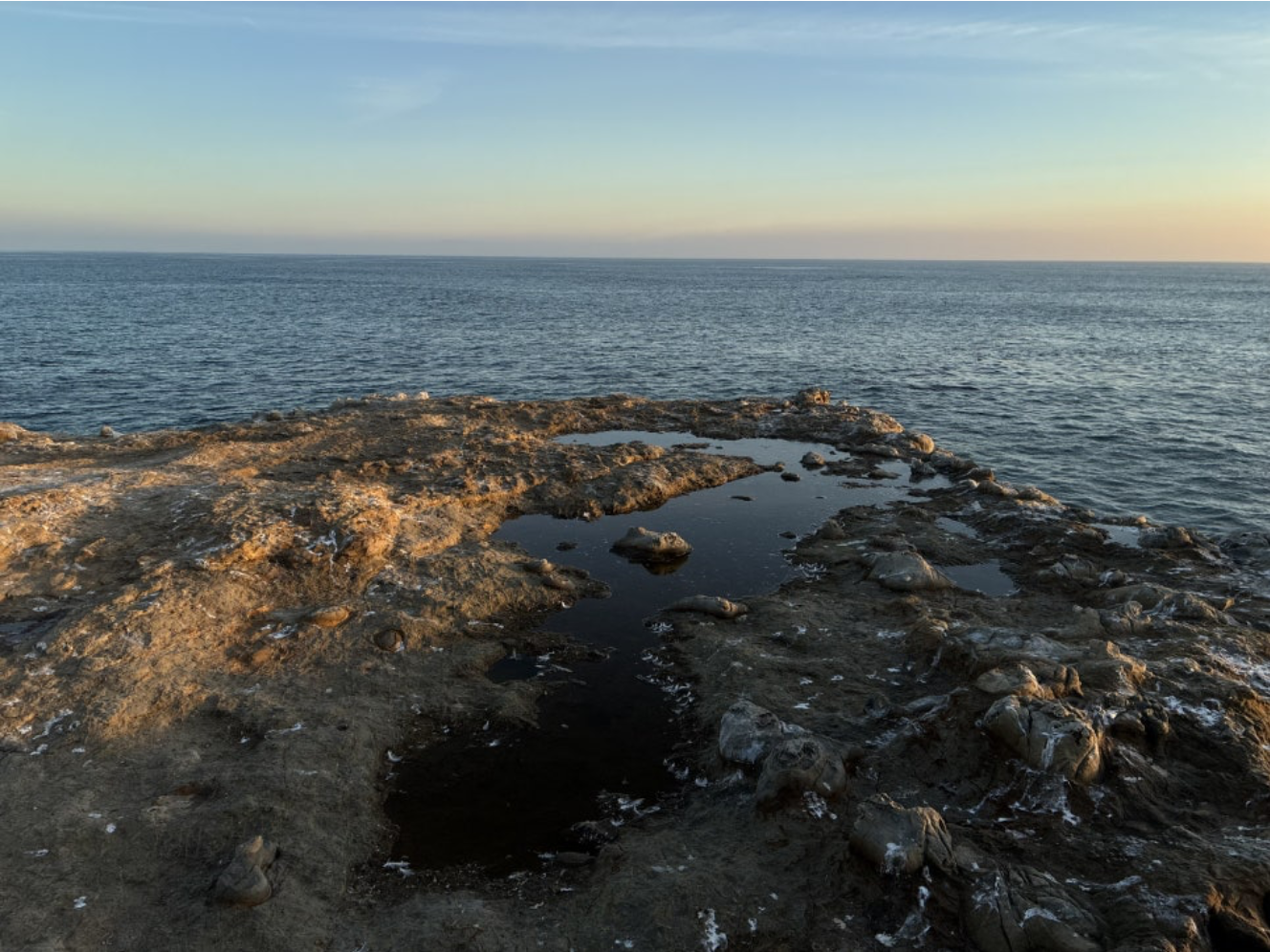 Rocky shoreline and the sea in evening light