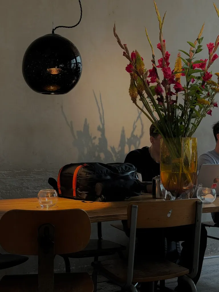 Flowers and people at a cafe table